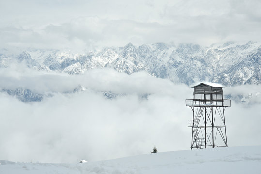 Watch tower in snow caped mountains are very important structures. They help in keeping birds eye watch over the slopes. This is an image of a tower overlooking Himalaya mountain peeks surroundings