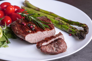 Steak on a white plate with vegetables