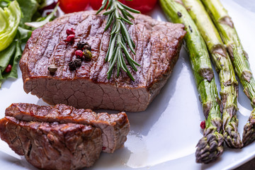 Steak on a white plate with vegetables