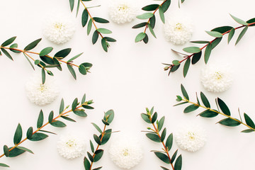 Wreath frame with white flowers and branches isolated on white background. flat lay, overhead view