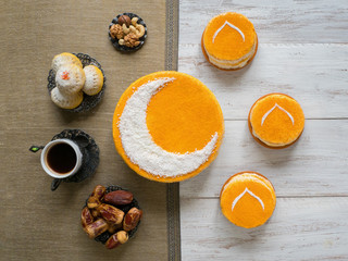 homemade golden cake with a Crescent moon, served with black coffee and dates
