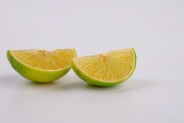 Fresh lime slice isolated on white background. Close-up.
