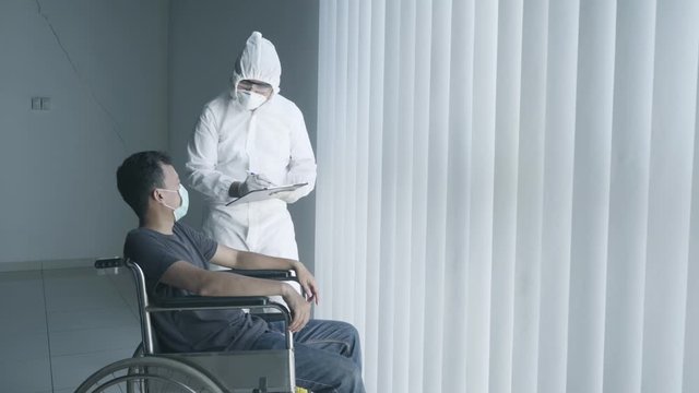 Disabled man describing his symptoms to a doctor