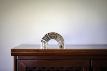 Metallic gold rainbow on plain background. Basic background image.