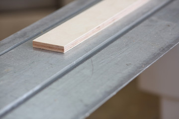 Wooden bars lying in a row closeup background. DIY job inspiration improvement fix shop powersaw bench joinery startup workplace idea career ruler industrial education