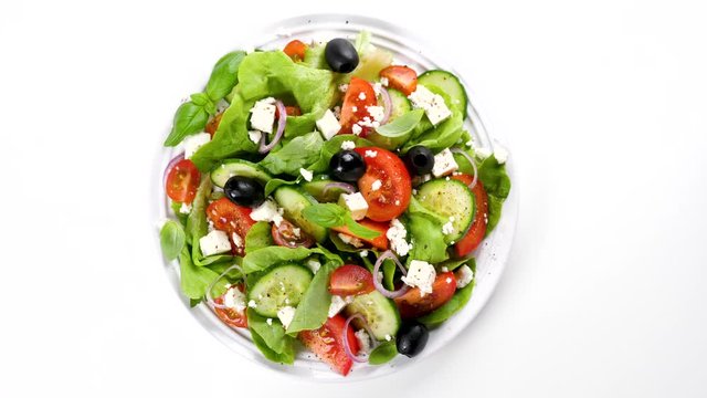 vegetable salad with cucumber, tomato, olive and feta cheese isolated on white background