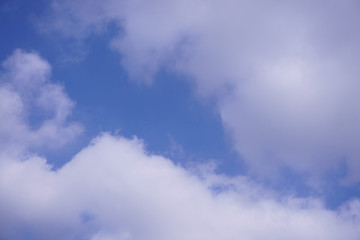 white fluffy clouds under deep blue sky