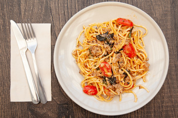 Spaghetti bolognese with tomato, cheese and basil on a plate