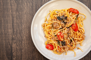 Spaghetti bolognese with tomato, cheese and basil on a plate
