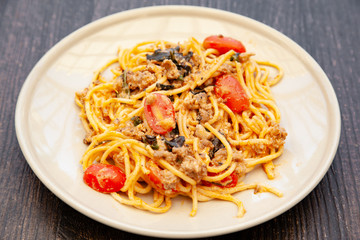 Spaghetti bolognese with tomato, cheese and basil on a plate