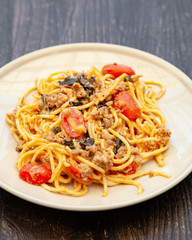 Spaghetti bolognese with tomato, cheese and basil on a plate