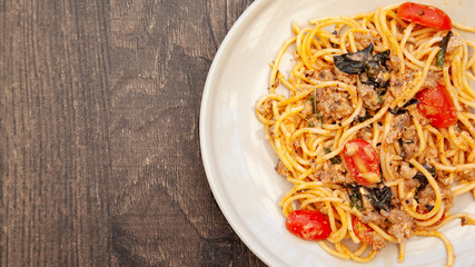 Spaghetti bolognese with tomato, cheese and basil on a plate