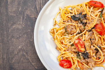 Spaghetti bolognese with tomato, cheese and basil on a plate