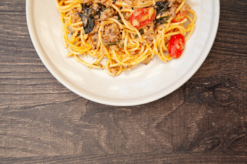 Spaghetti bolognese with tomato, cheese and basil on a plate