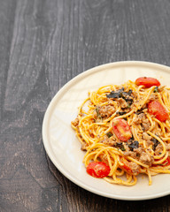 Spaghetti bolognese with tomato, cheese and basil on a plate