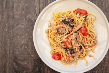 Spaghetti bolognese with tomato, cheese and basil on a plate