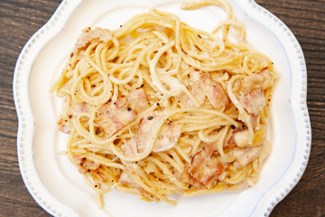 Carbonara pasta, spaghetti with pancetta, egg, hard parmesan cheese and cream sauce. Traditional italian cuisine