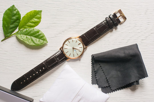 Close up cleaning modern watch with microfiber cloth and Cleaner cream concept.Cleaning modern watch by Cleaner cream.Cleaning stainless steel by Cleaner cream,Cleaning leather by Cleaner cream,