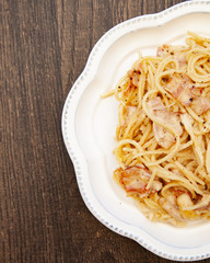 Carbonara pasta, spaghetti with pancetta, egg, hard parmesan cheese and cream sauce. Traditional italian cuisine