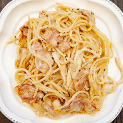 Carbonara pasta, spaghetti with pancetta, egg, hard parmesan cheese and cream sauce. Traditional italian cuisine