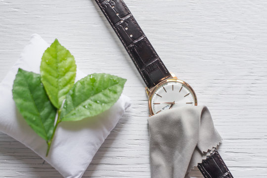 Close up cleaning modern watch with microfiber cloth and Cleaner cream concept.Cleaning modern watch by Cleaner cream.Cleaning stainless steel by Cleaner cream,Cleaning leather by Cleaner cream,