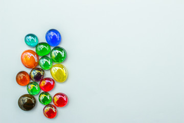 Abstract art design background of colorful glass drop dragon tears on a light neutral background with copy space