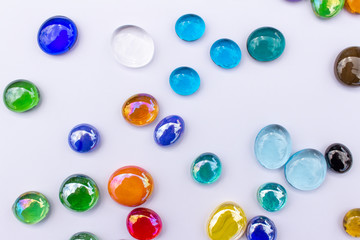 Abstract art design background of colorful glass drop dragon tears on a light neutral background...