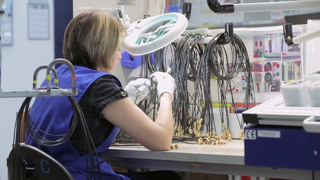 A woman in the workplace checks for cable defects