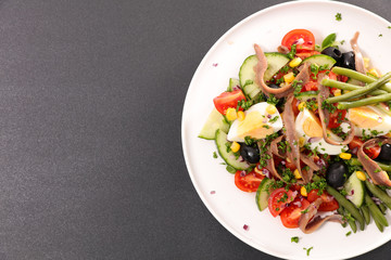 vegetable salad with egg, cucumber, tomato, olive and anchovy