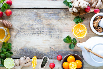 Healthy products for Immunity boosting on wooden background with copy space top view. Lemon, nuts,...