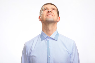 a businessman in a light shirt raised his head, staring at the top. Isolated