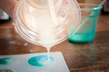 Pouring white glitter resin into mold , process of prepare for make an accessories