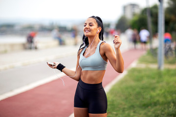 Beautiful young long hair woman listen music and enjoy and relax after jogging