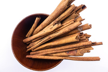 cinnamon in bowl on white background.