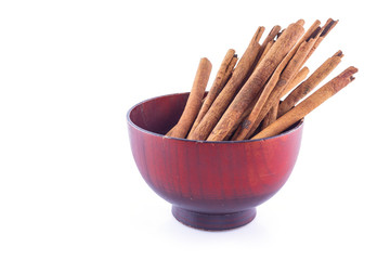cinnamon in bowl on white background front view.
