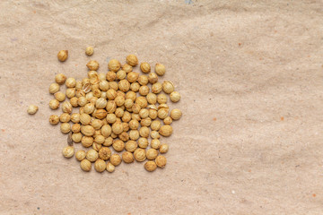 Fototapeta na wymiar coriander seeds top view on brown paper background.