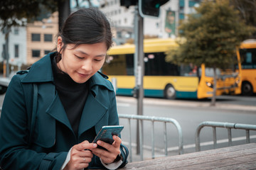 Woman using smartphone on Wellington city street