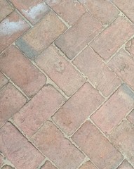 The ground covered with many red bricks that can be used as a background