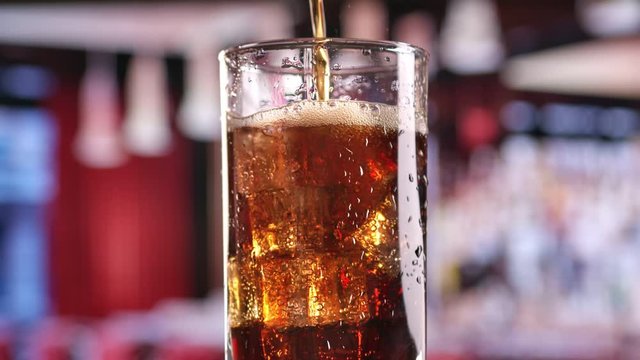 Slowmo cola fizzy cocktail in bocal isolated at nightclub party. Shot on RED Raven 4k Cinema Camera