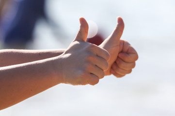 A man shows a thumbs up with his hands.