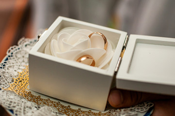 Gold wedding rings in the white box