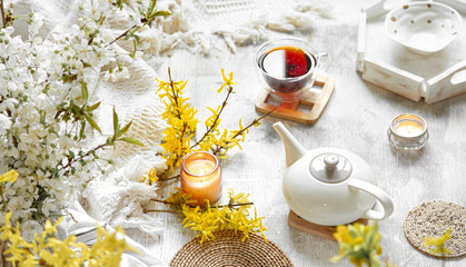 Spring still life with a Cup of tea and flowers .
