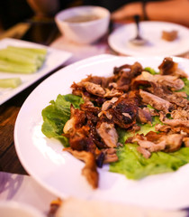 Peking duck in a plate on the table.