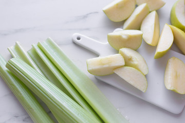 fresh green apple and celery on marble table