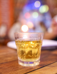 A glass glass with a drink stands on a table