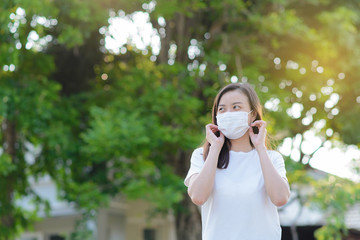 Masked woman - protection against influenza virus. Asia woman wearing mask for protect. Woman wear with protective face mask at home. Stop the virus and epidemic diseases.