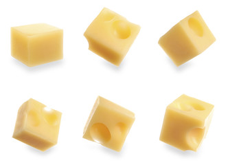 Set of delicious cheese cubes on white background