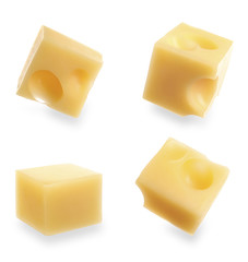 Set of delicious cheese cubes on white background