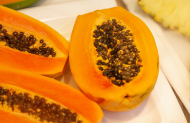 Sliced papaya fruits on a counter