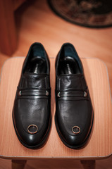 Pair of gold wedding rings on the black shoes